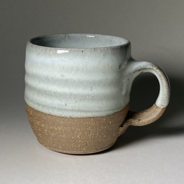 Pottery mug decorated with a Chun glaze over an iron-rich clay.